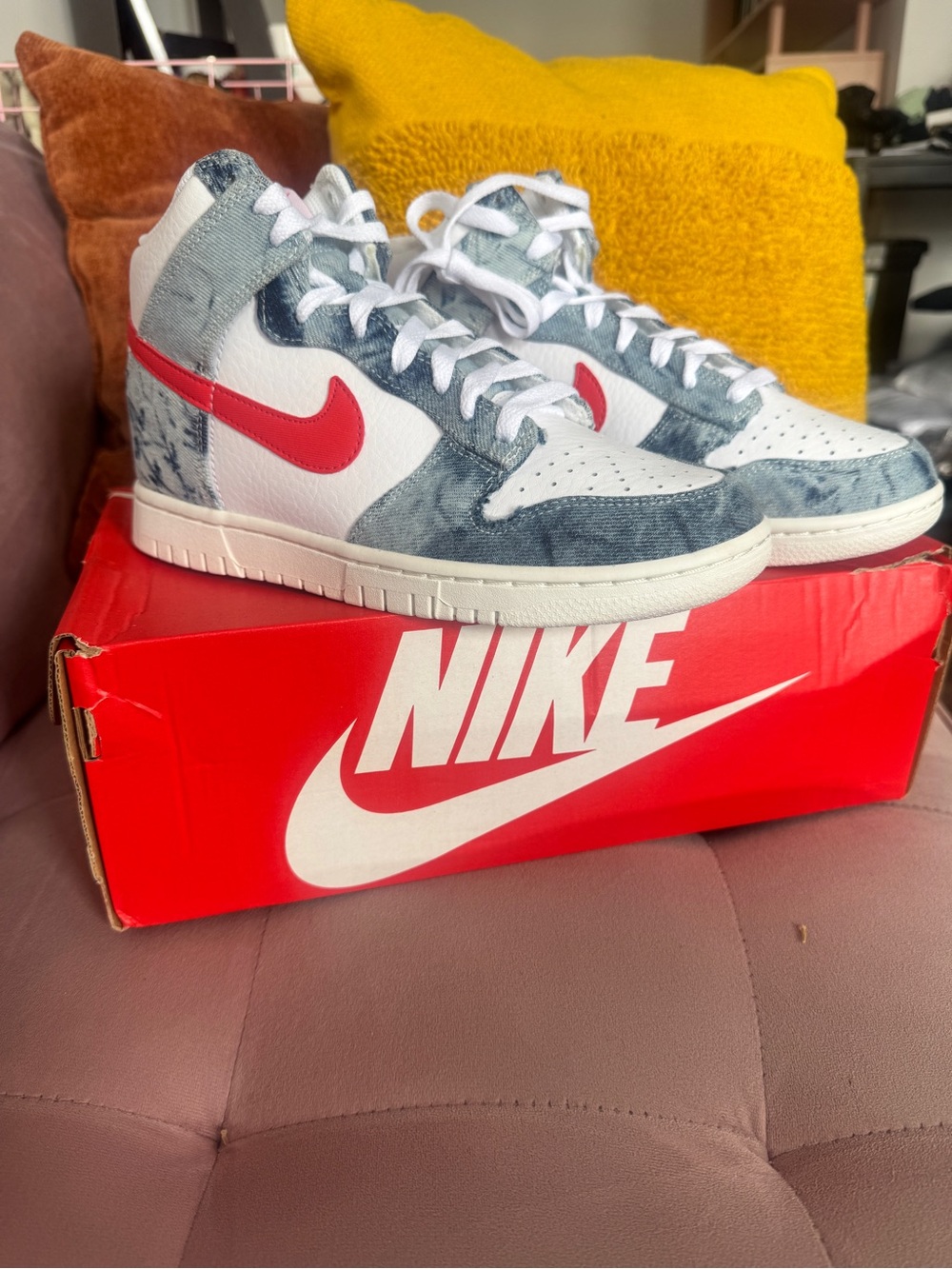 Women’s Nike Dunk High in denim wash with Habanero Red swoosh accents
